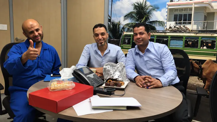 Three learners gathered around a table